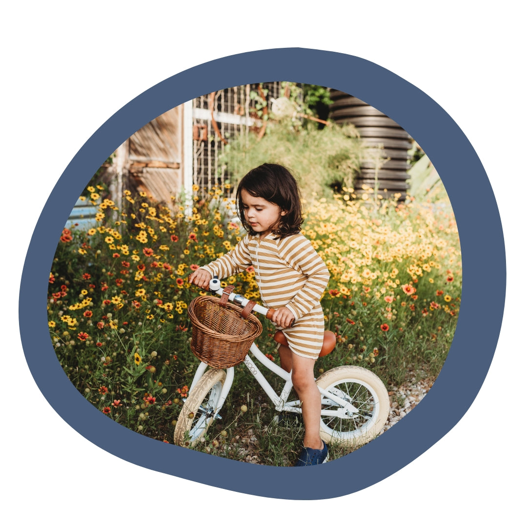Banwood - child riding bike with wicker basket