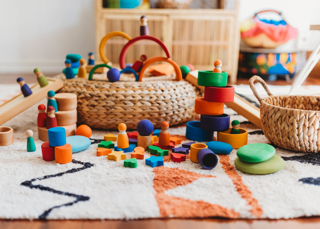 Inspiring the Imagination | Image of rainbow colored wooden toys  by Grimms
