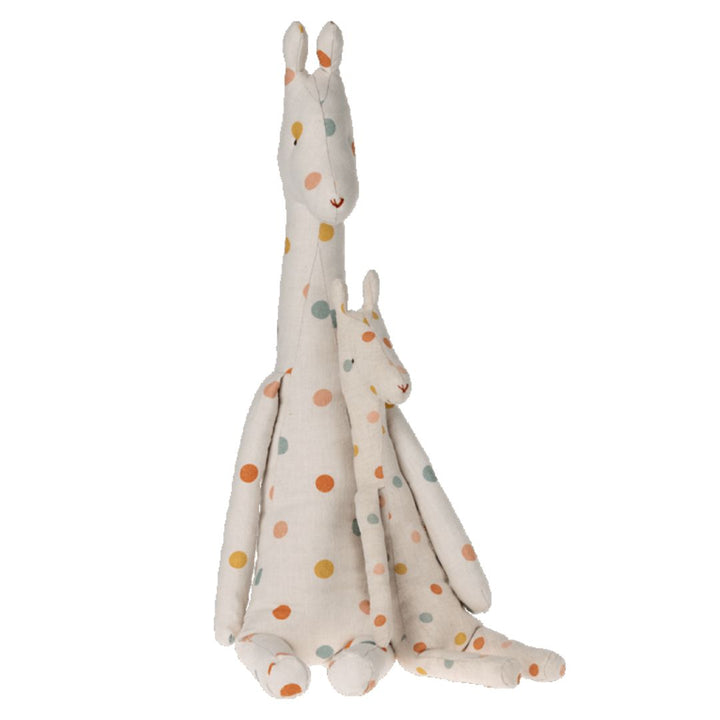 Maileg big white giraffe stuffed toy with colorful polkadots sitting with a smaller version of the same toy.