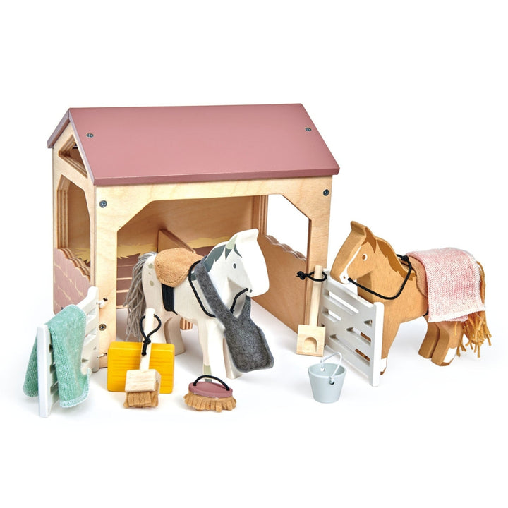 Tender Leaf Toys wooden Horse stable with 2 horses and accessories.