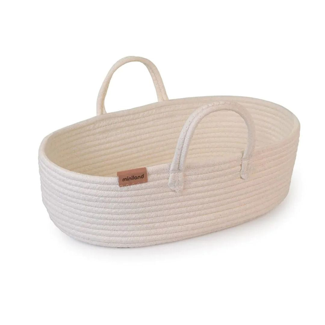 Cream-colored cotton doll basket carrier with two handles, designed for Miniland dolls up to 15¾ inches, displayed on a white background.