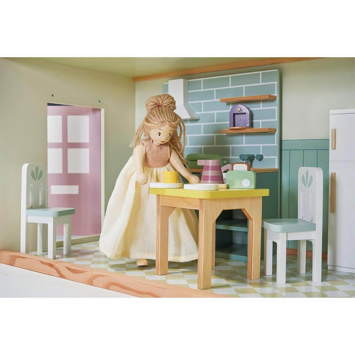 Ferne Wooden Doll standing in kitchen of Tender Leaf Toys Mulberry Mansion Wooden Dollhouse