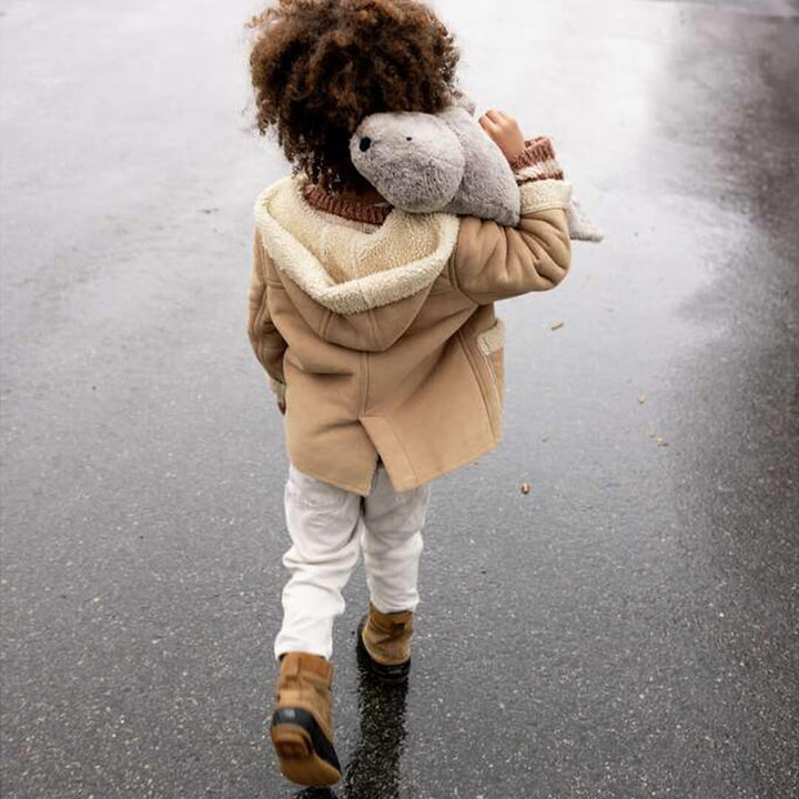 Child walking with Organic Grey Seal Warming Pillow