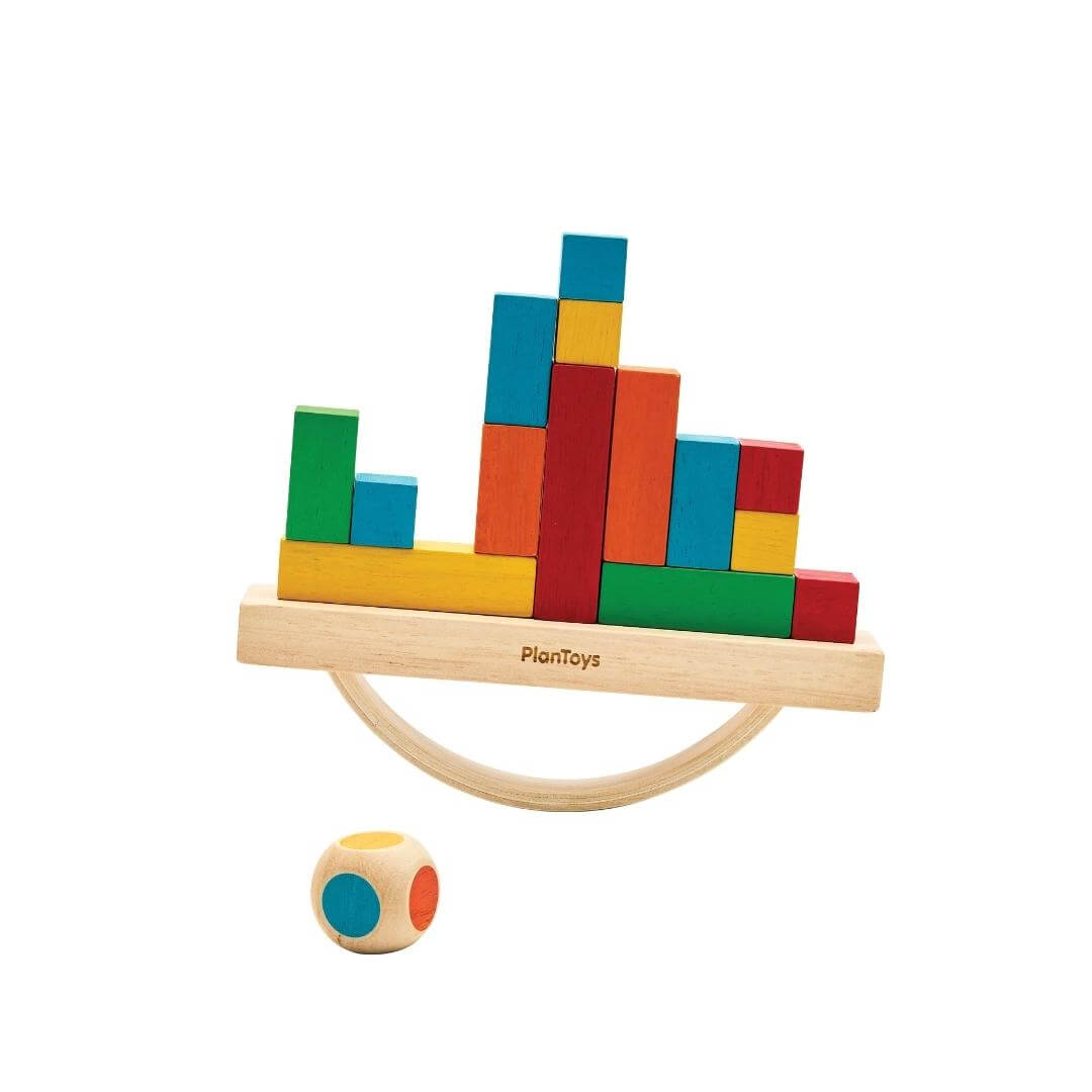 PlanToys Montessori Balancing Cargo Set with rocking wooden boat, colorful blocks stacked on top, and a color-die included.