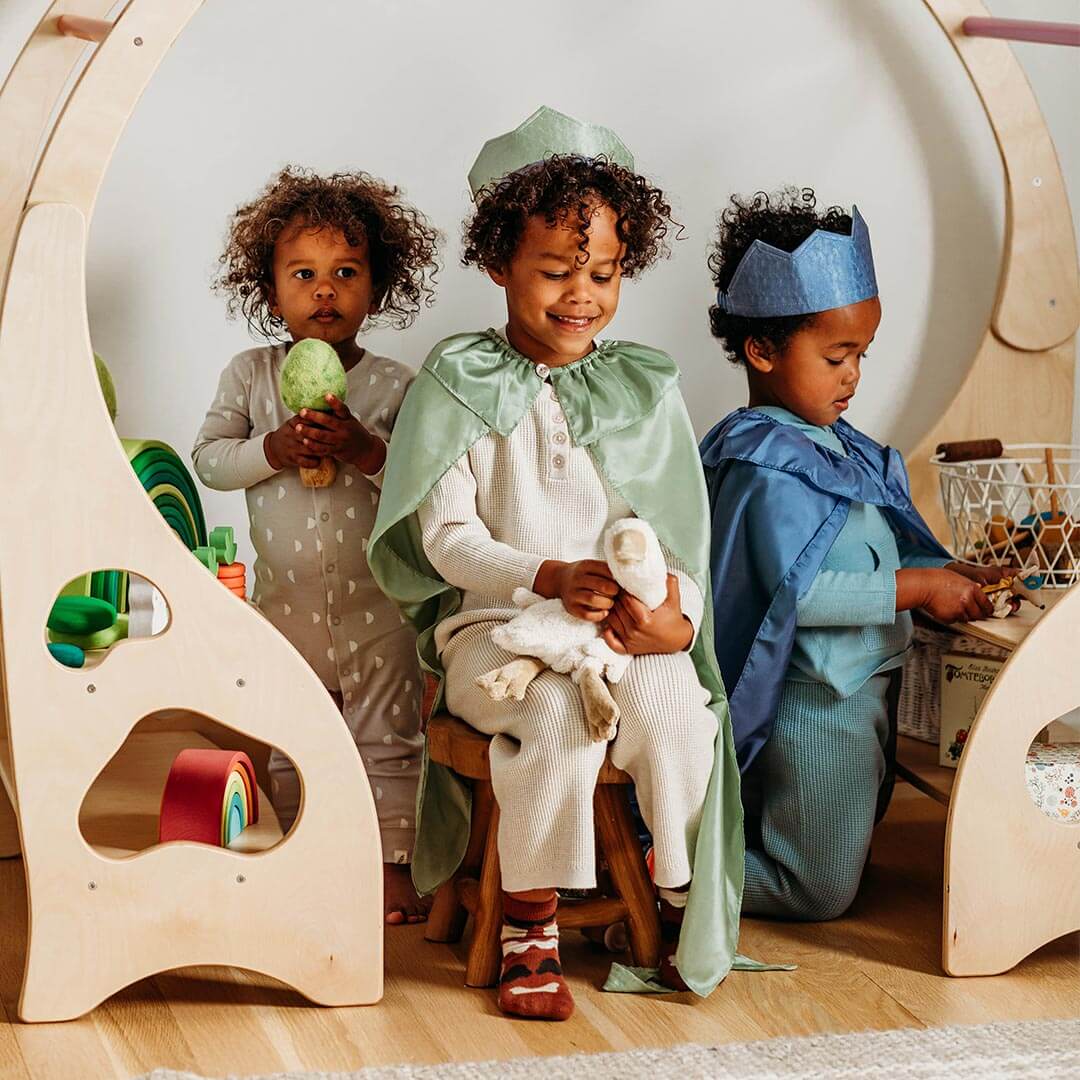 Boys playing in Sarah's Silks capes and crowns