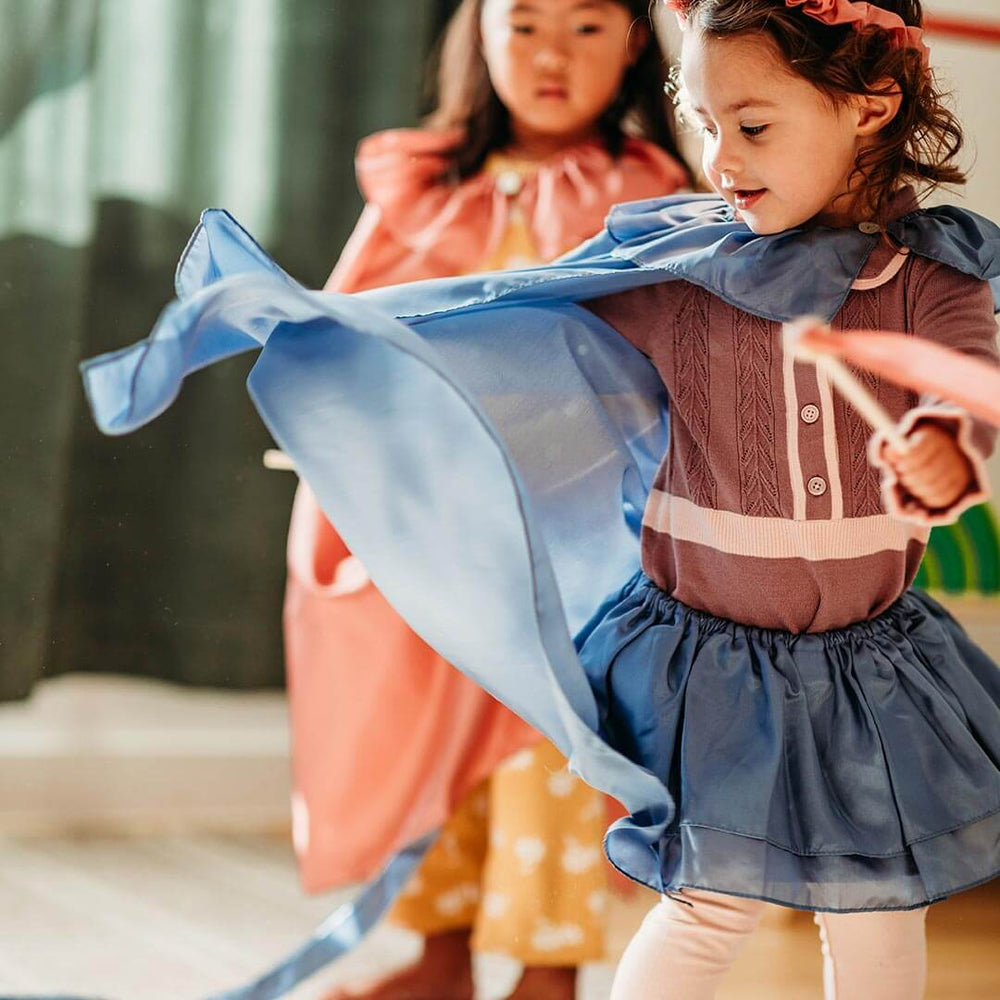 Girl twirling with Sara's Silks Cape in Tidewater