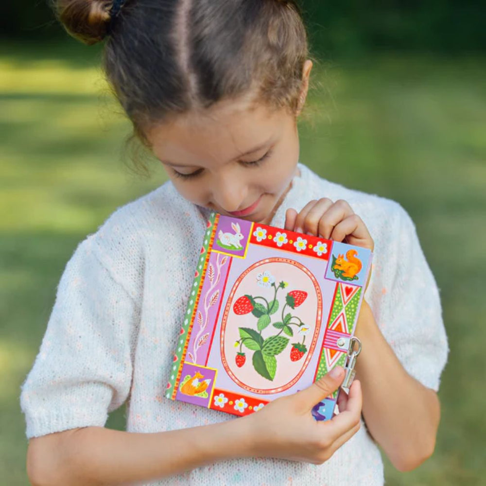 eeBoo- Child holding small journal that has strawberries design -Bella Luna Toys