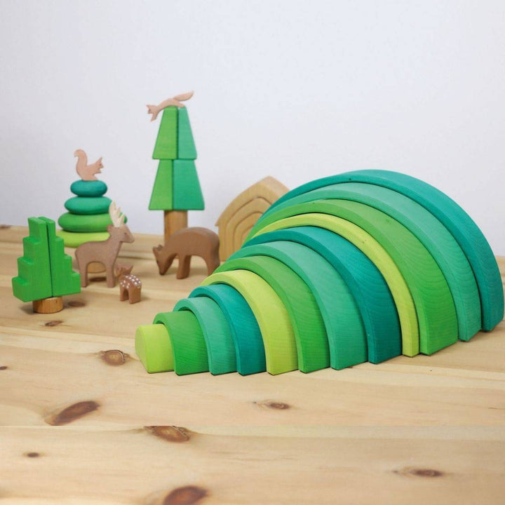scene showing Grimm's Wooden Rainbow Forest Green Tunnel with trees and forest animals.