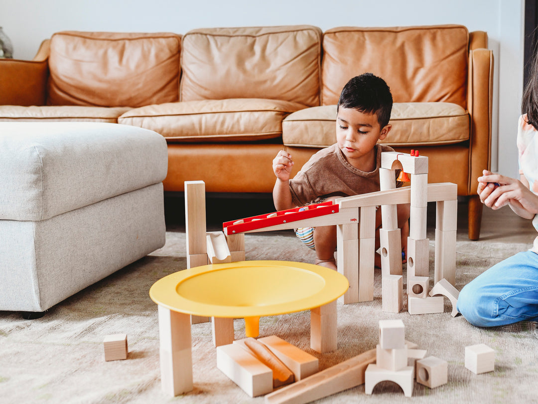 Child playing with HABA Wooden Ball Track Marble Run