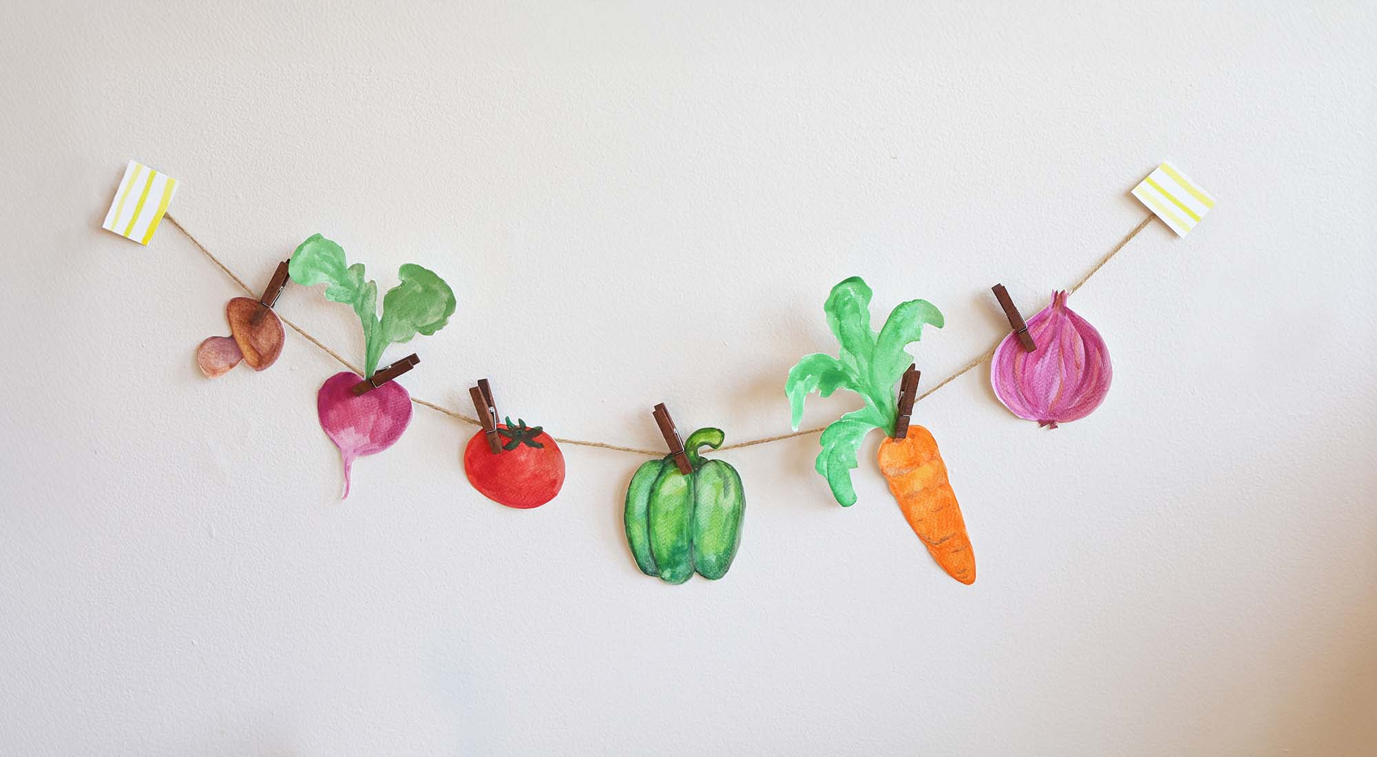 Watercolor veggies on a string.