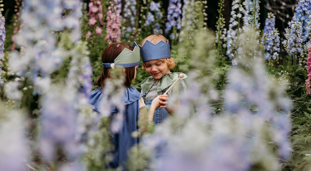 Two kids playing in flowers.