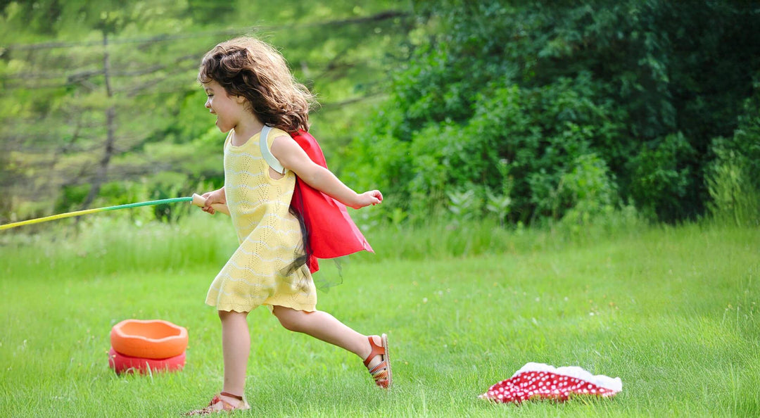 A girl running outside with toys around.