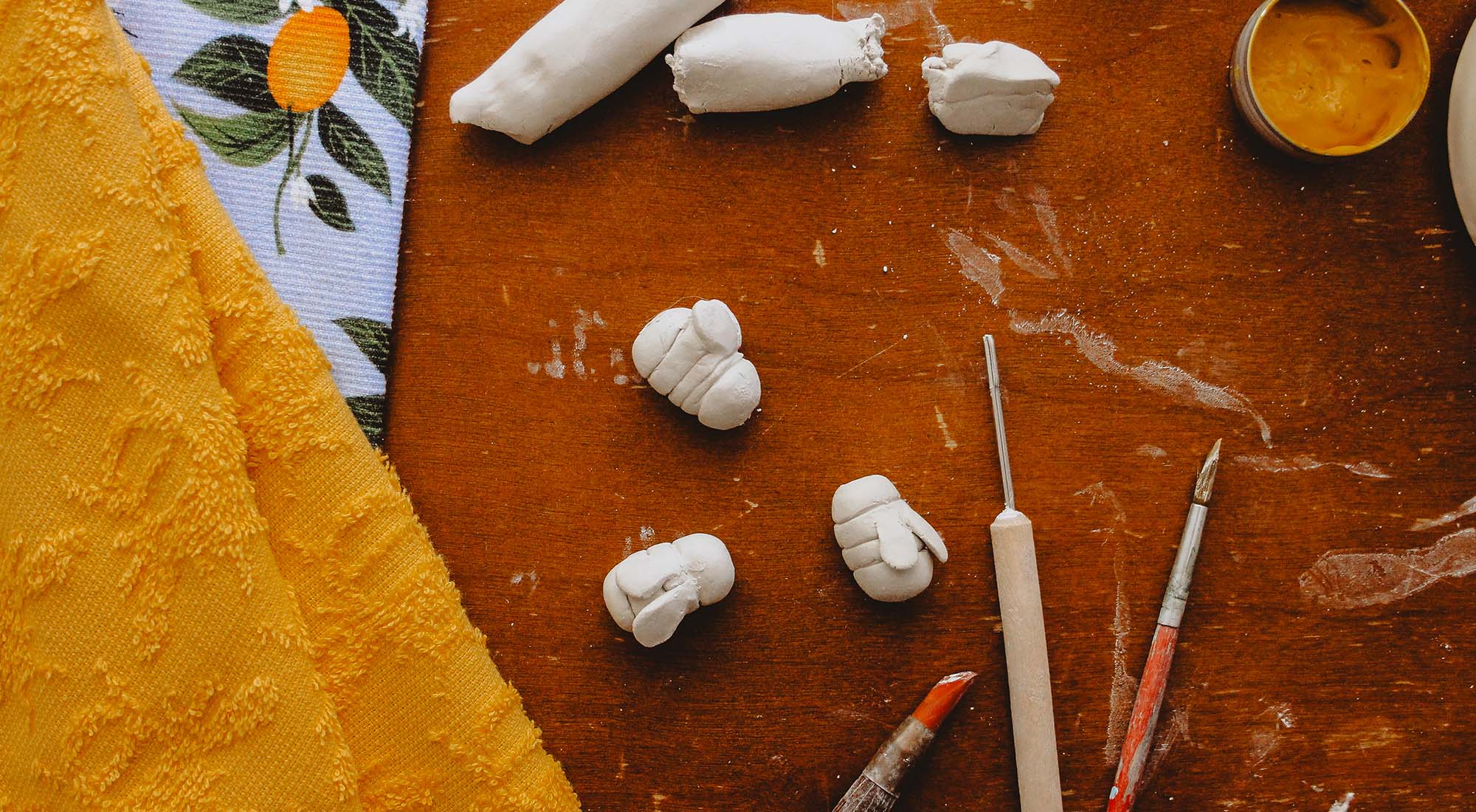 Bee shaped beads on a wooden table.