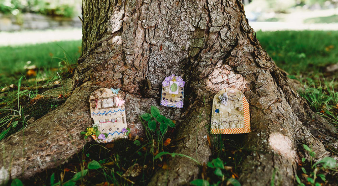 Magical Fairy Door craft outside by a tree.