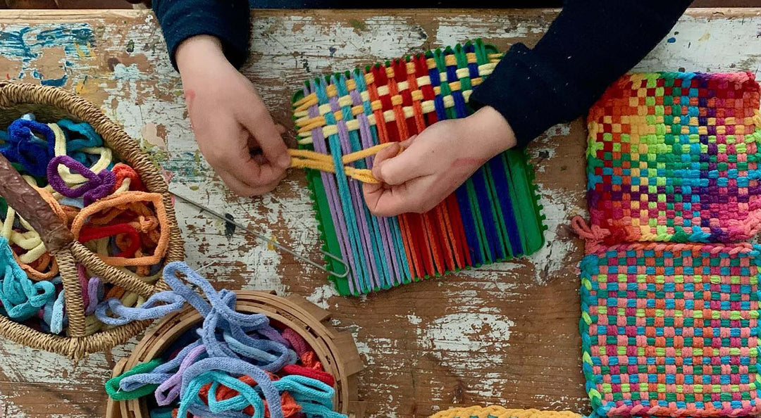 busy hands are crafting on a Bella Luna Toys potholder loom.