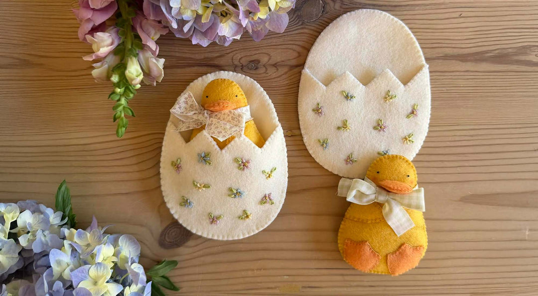 Felt Duckling and Egg Pocket on a wooden table.