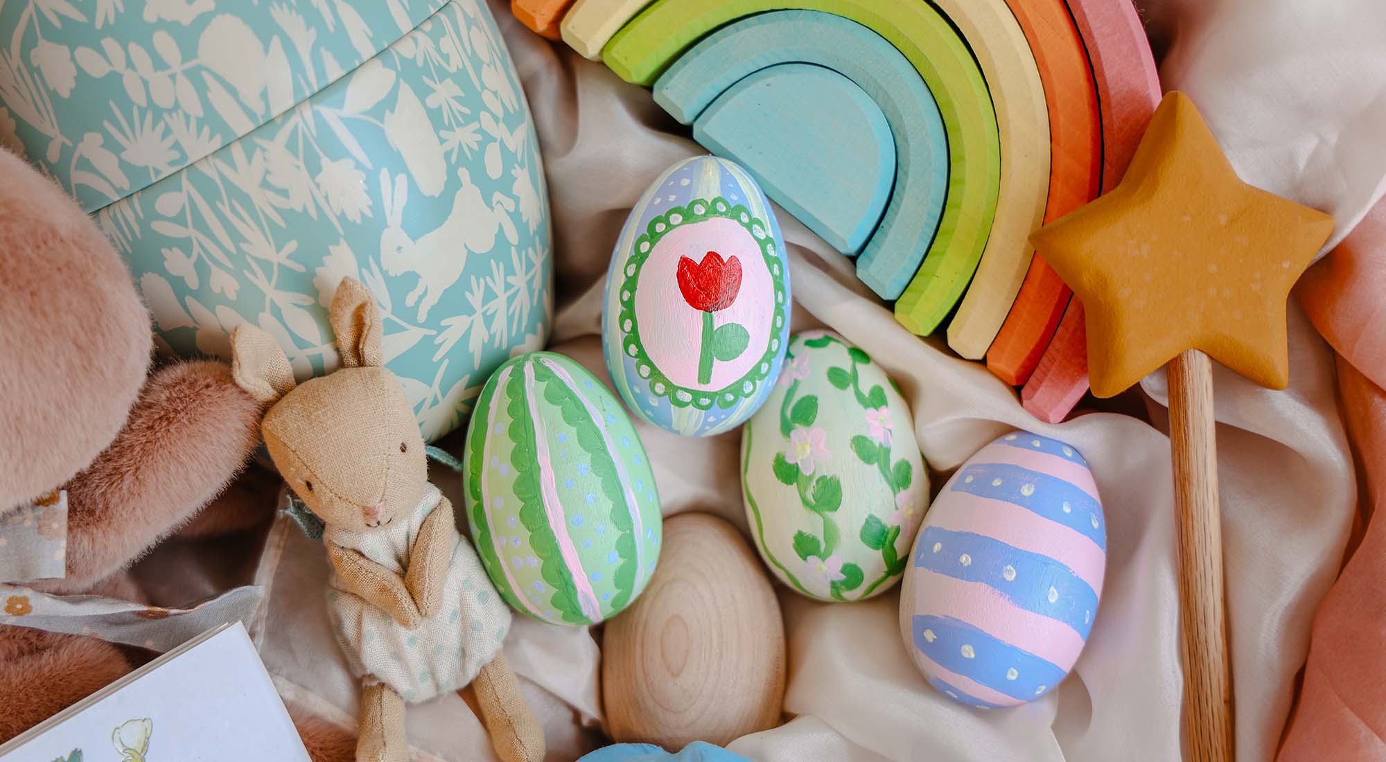 A collection of Easter goodies in a basket with colorful eggs.