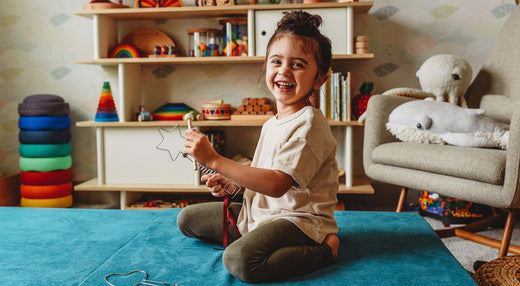 A child is using a magic music wand.