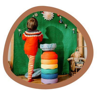 A kid is in a holiday scene with Stapelstein Stepping Stones.
