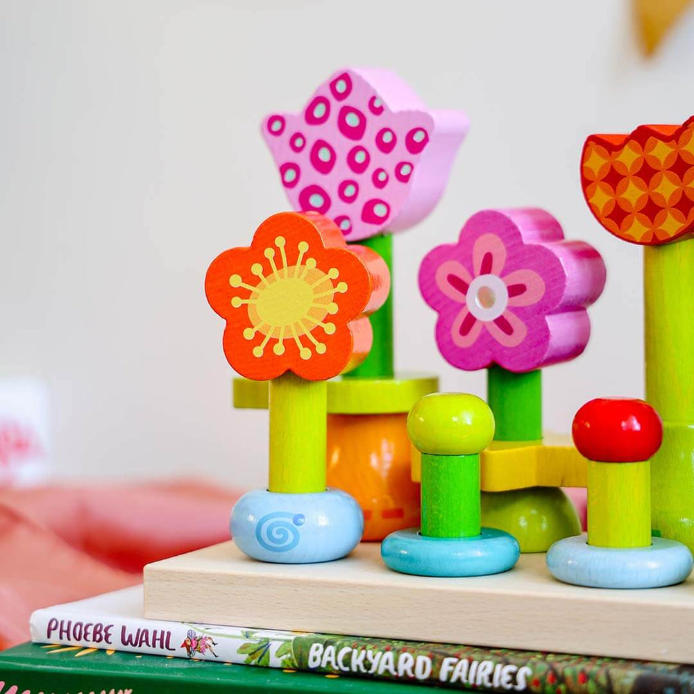 Colorful wooden flower wooden toy on a book with a blurred background.