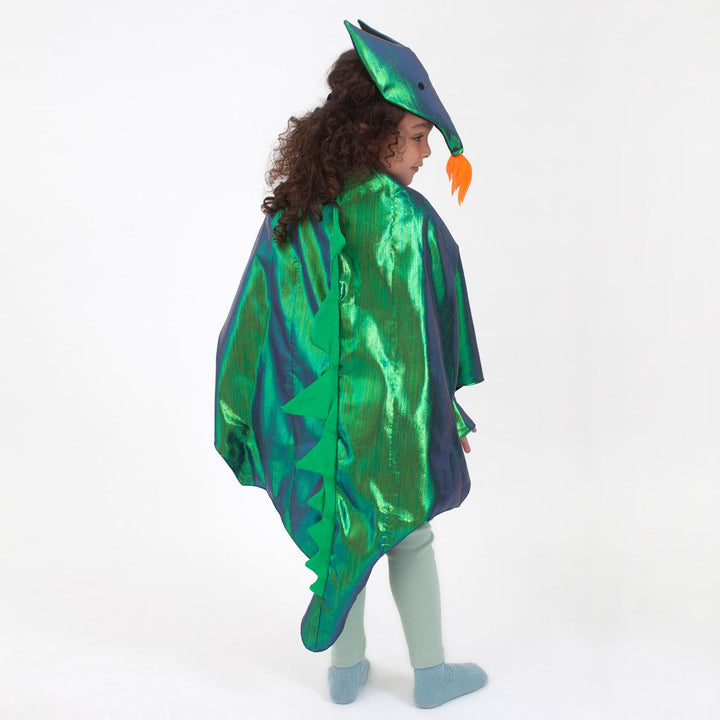 Child wearing the green metallic dragon costume set from Meri Meri with winged cape and dragon headpiece featuring flame detail and embroidered eyes as seen from the back against a white background.