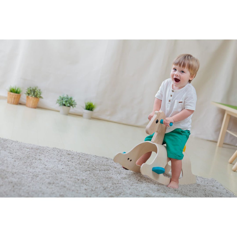 Child riding on PlanToys - Wooden Palomino Rocking Horse - Bella Luna Toys
