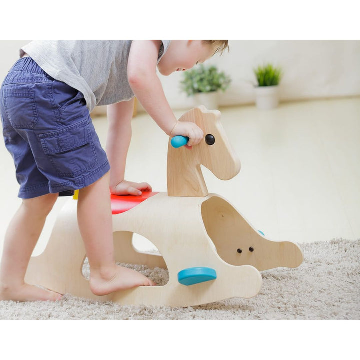 Child getting on PlanToys - Wooden Palomino Rocking Horse - Bella Luna Toys