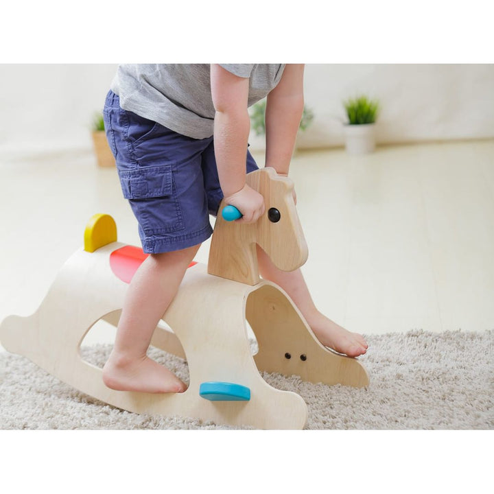 Child riding PlanToys - Wooden Palomino Rocking Horse - Bella Luna Toys