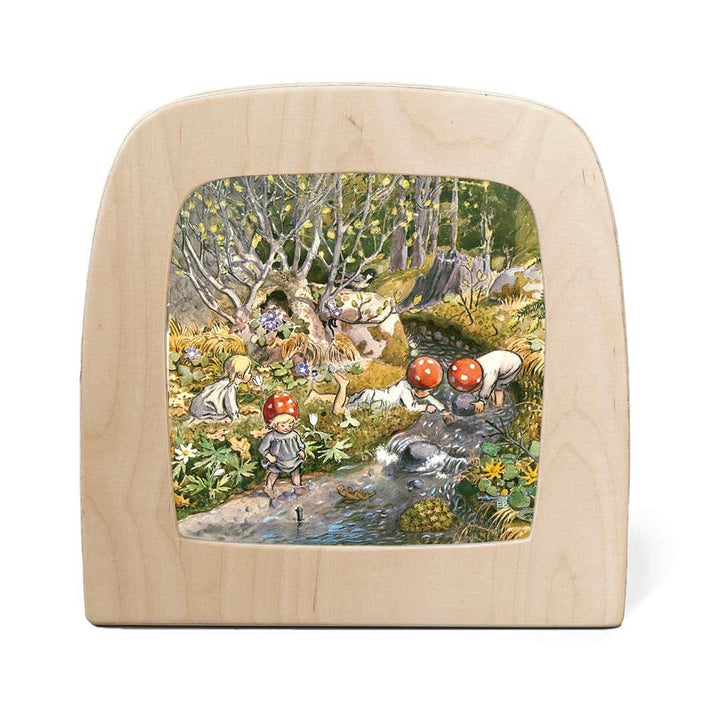 Wooden light with a painted scene of children in a forest on a white background