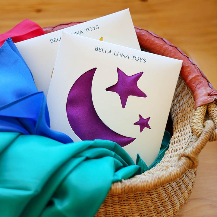 A collection of Classic Rainbow Play Silks in a bolga basket.