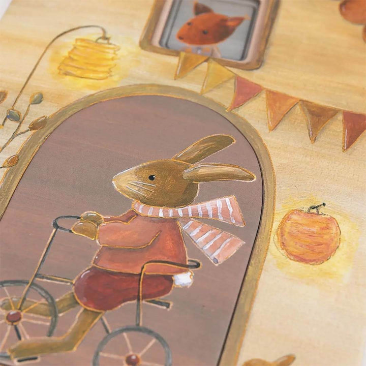 Illustration of a rabbit riding a bicycle with autumn elements like pumpkins and leaves - Bella Luna Toys