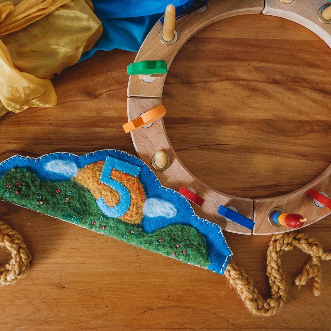 Wooden ring with colorful elements on a wooden surface