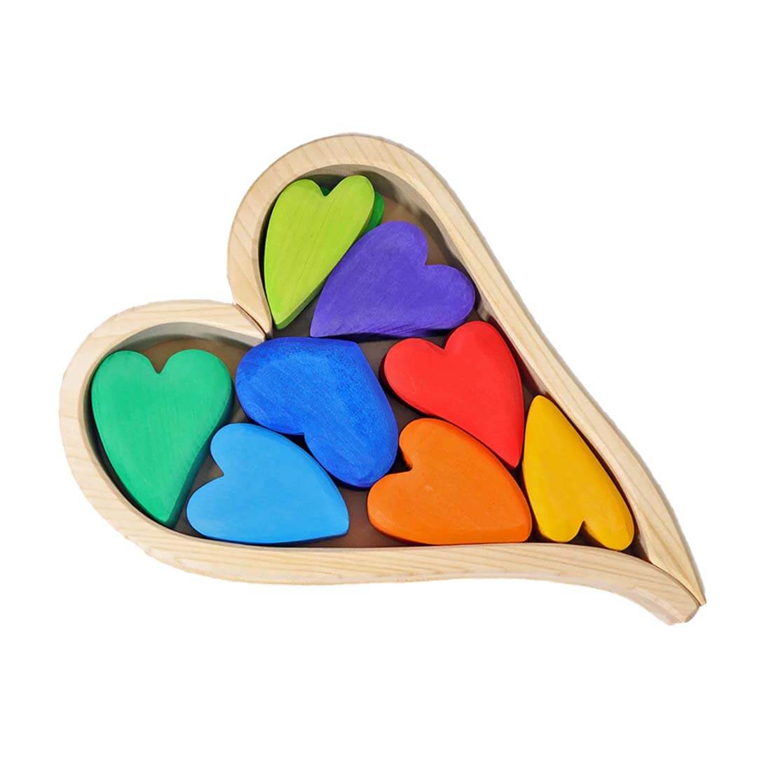 Heart-shaped wooden blocks with colorful heart pieces on a white background