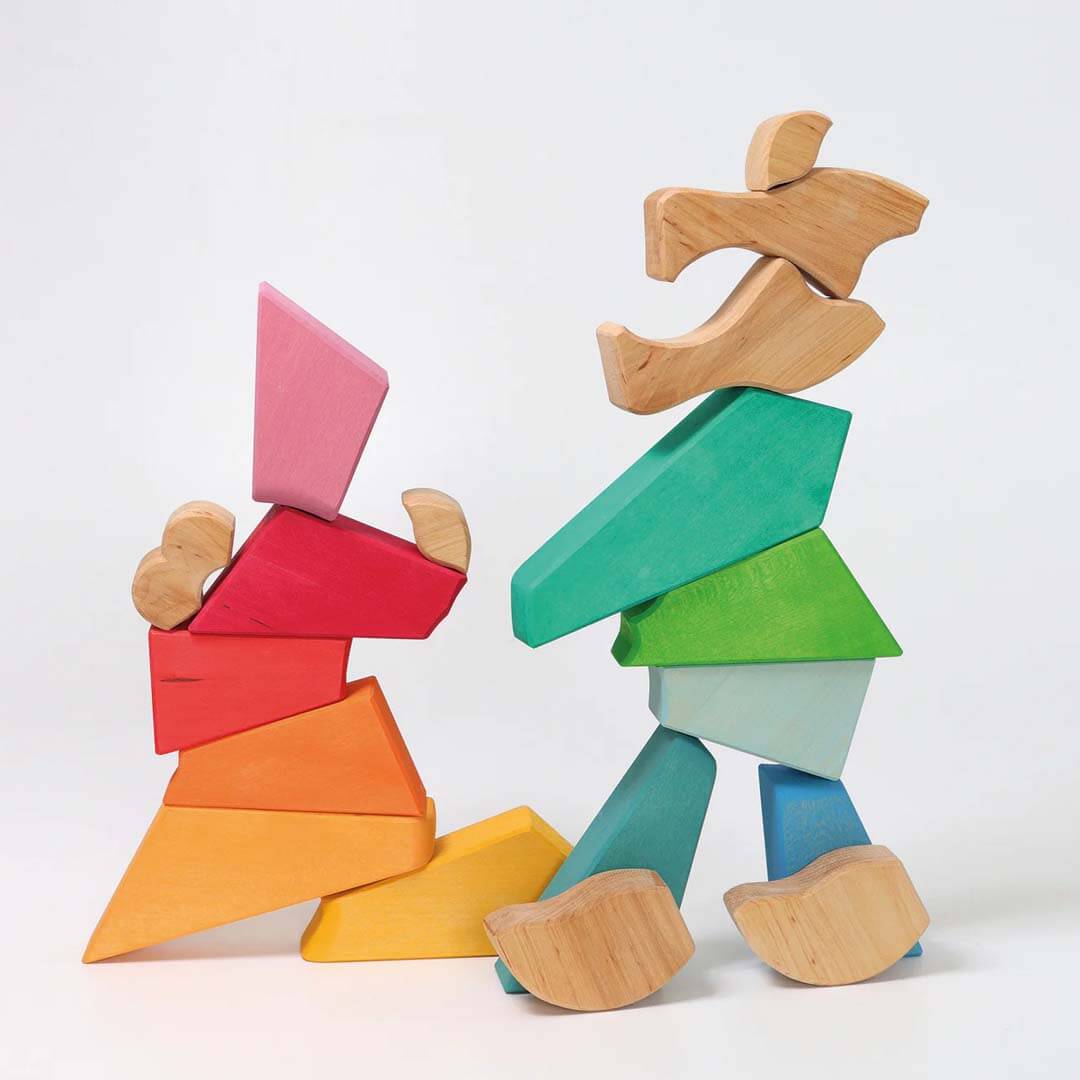 Colorful wooden block figures on a white background.