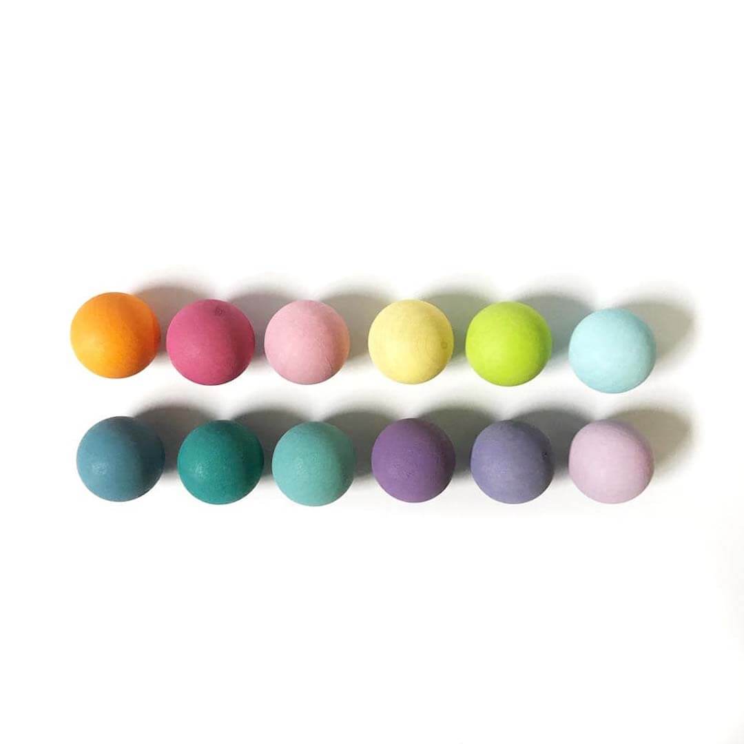 Colorful wooden balls on a white background.
