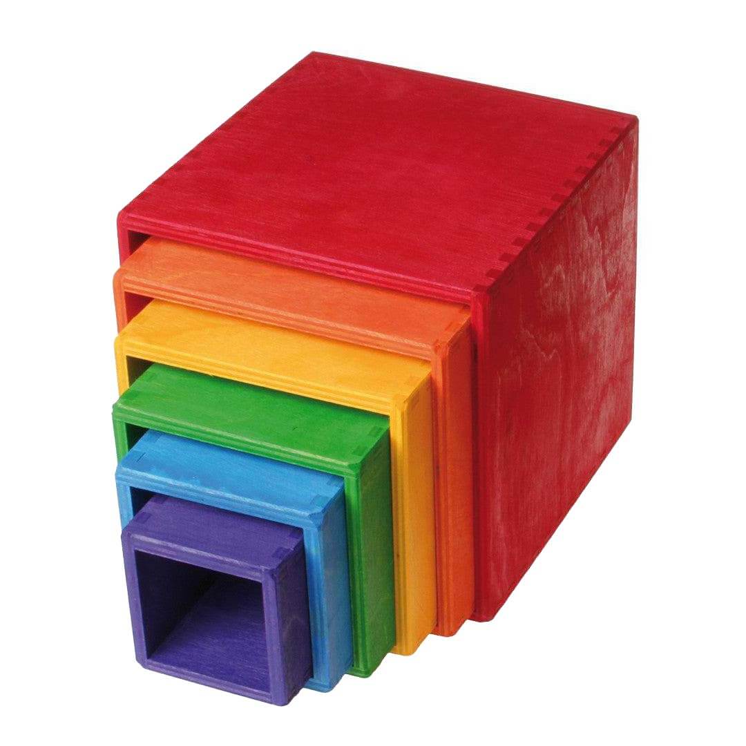 Set of colorful wooden cubes stacked on a white background.