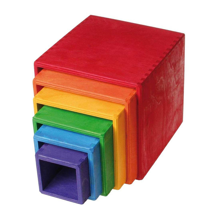 Set of colorful wooden cubes stacked on a white background.