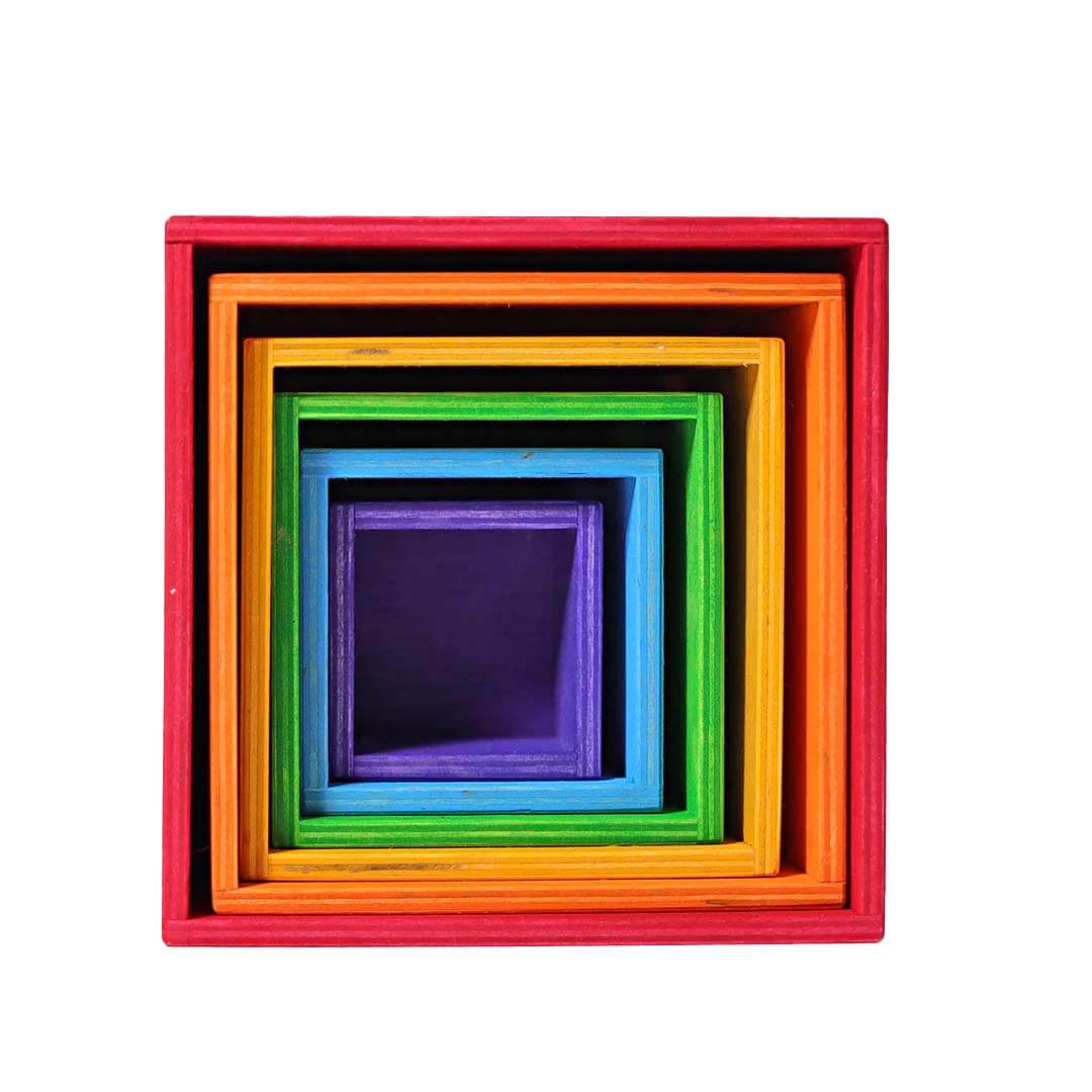 Set of colorful wooden cubes stacked on a white background.