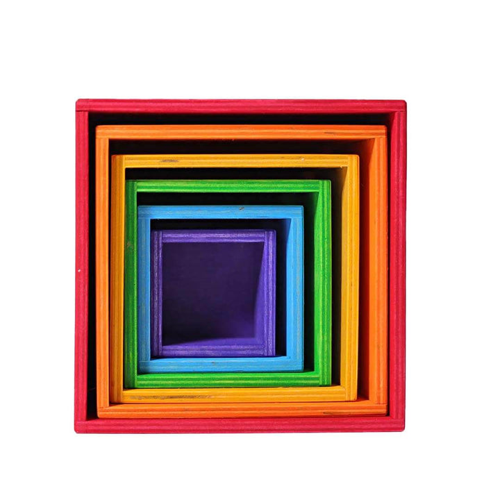 Set of colorful wooden cubes stacked on a white background.