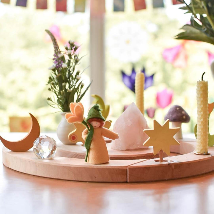 Wooden decorative set with figurines, crystals, and plants on a wooden base.