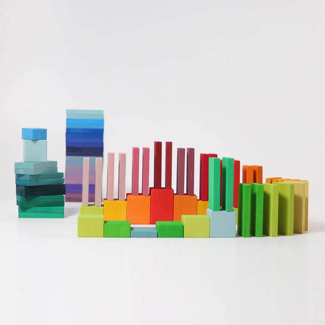 Colorful wooden blocks arranged in a pattern on a white background.