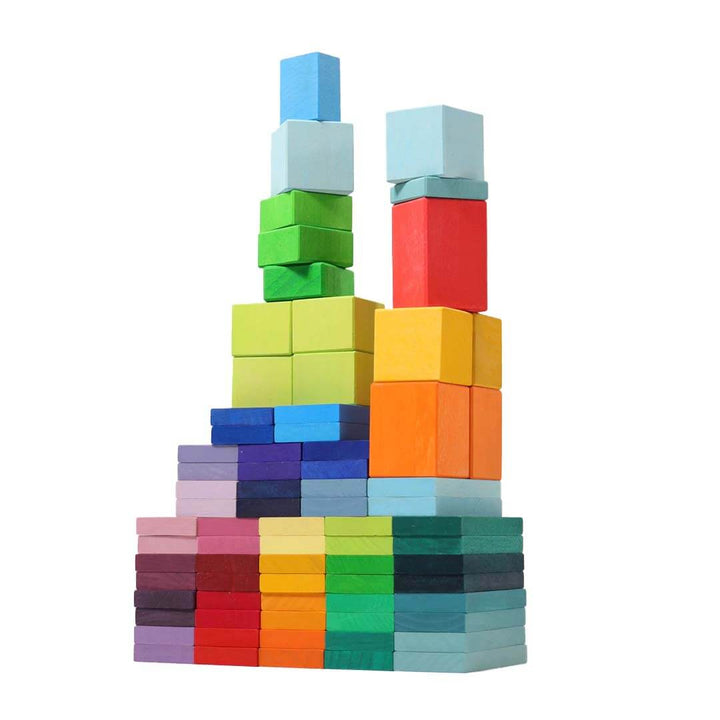 Colorful wooden blocks stacked in a tower on a white background.