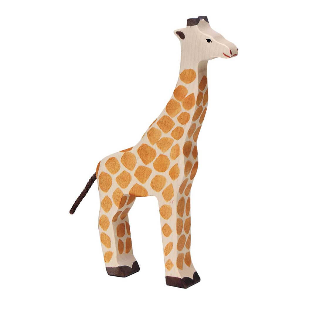 A handcrafted wooden giraffe figurine with natural beige wood grain, hand-painted orange-brown spots, and dark brown accents on its hooves, tail, and ears, set against a plain white background.