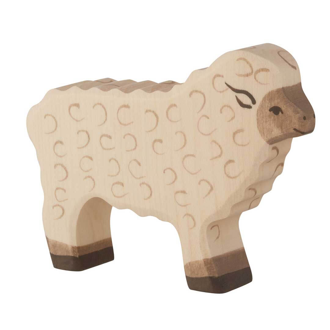 A handcrafted wooden toy sheep with a light natural wood body, darker brown hooves and snout, and engraved wool patterns, shown on a solid white background.