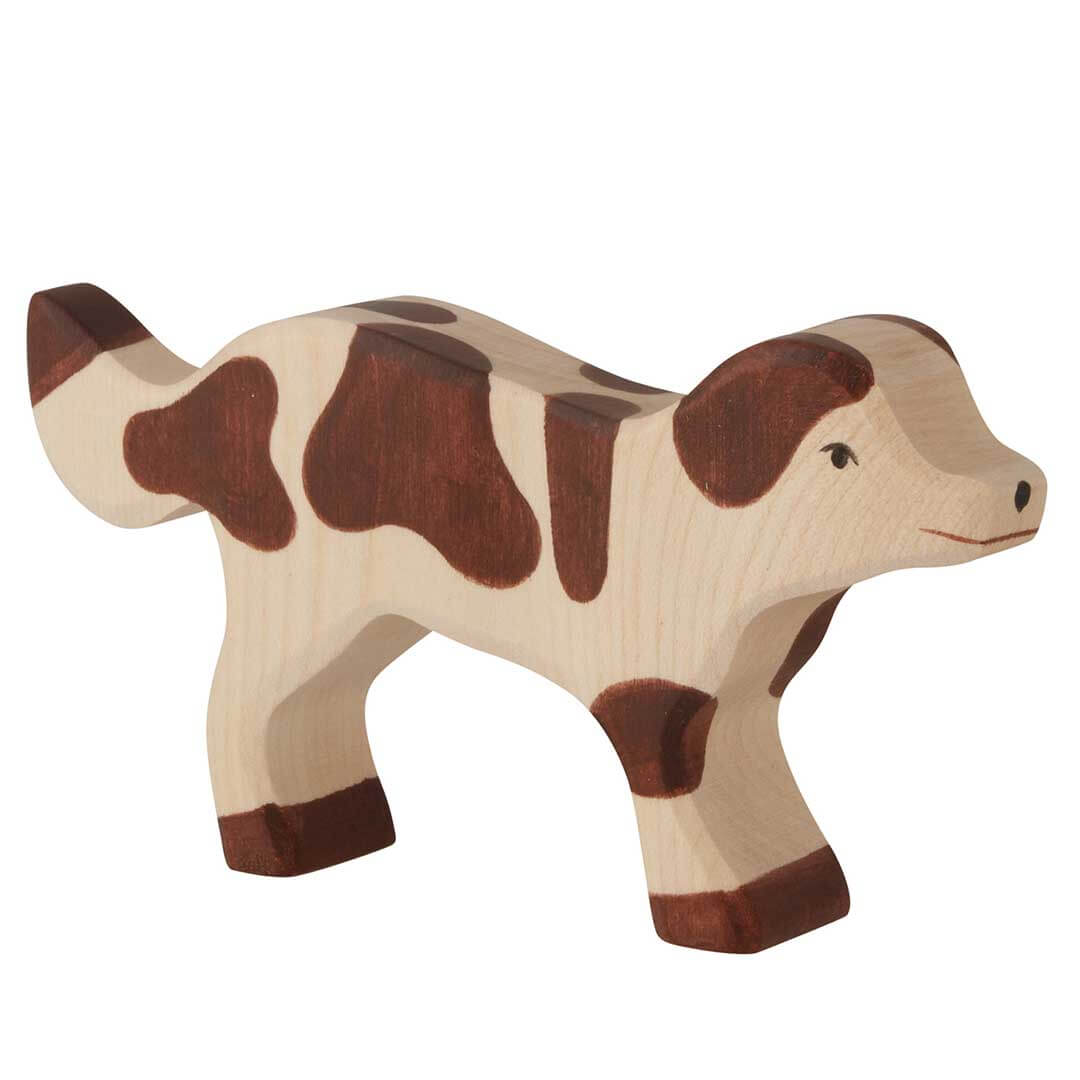 A wooden toy cow figurine with a natural light wood body and dark brown spots, shown on a plain white background.