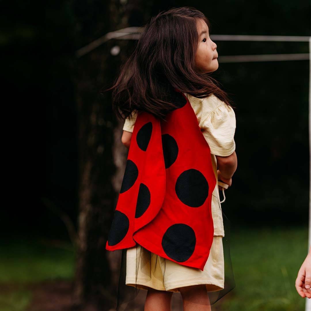 Ladybug Wings Costume with red wings with polkadots outside.