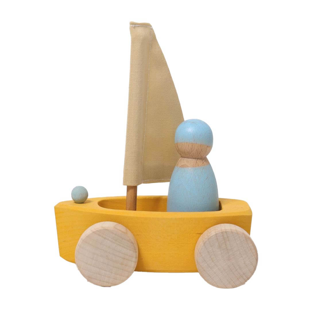 Wooden toy boat with a yellow body, beige sail, and blue figures on a white background