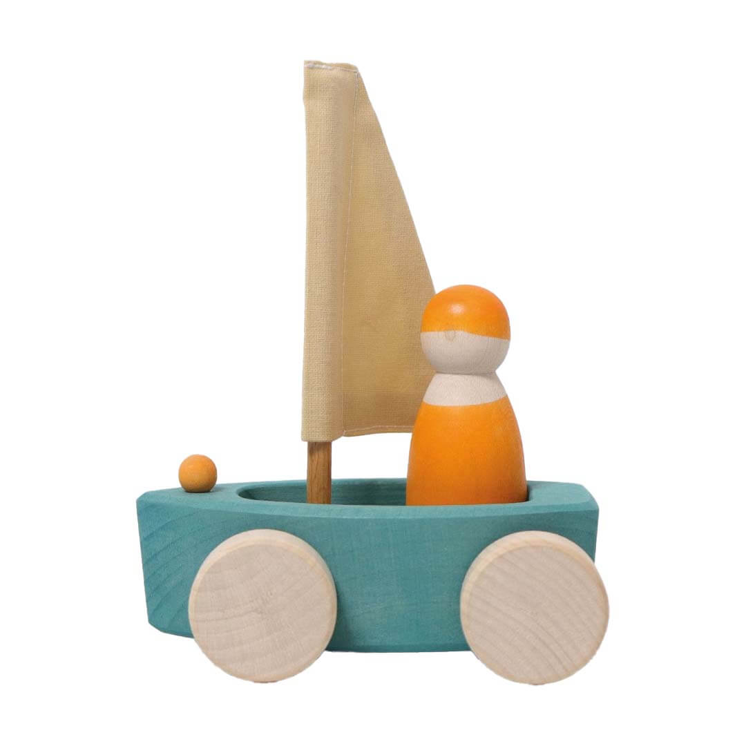 Wooden toy boat with a sail and wheels on a white background