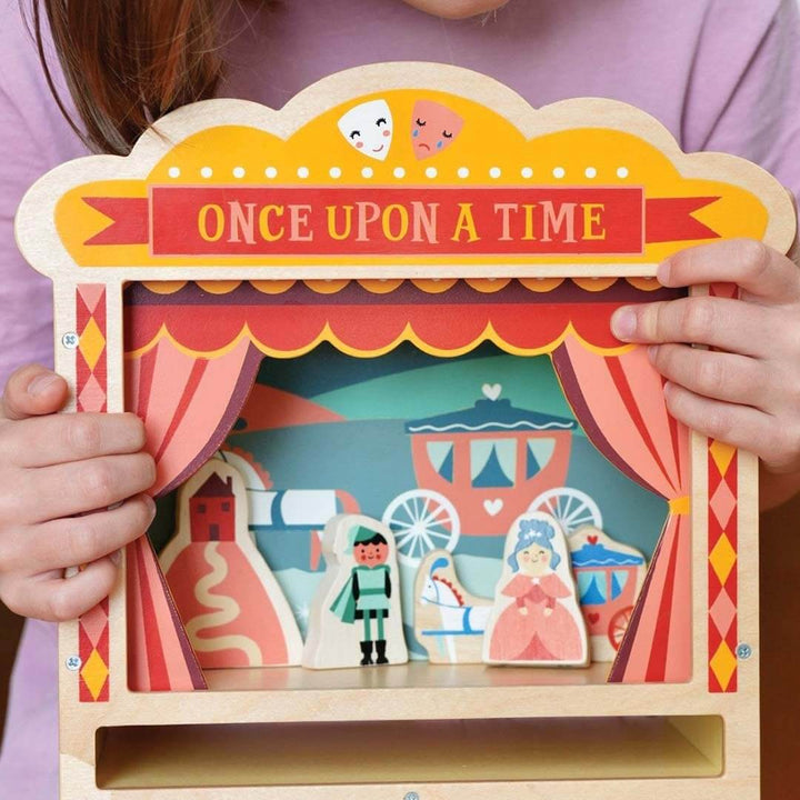 Wooden puppet theater with 'Once Upon a Time' sign and colorful cut-out characters.