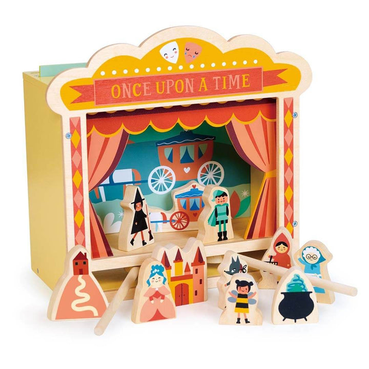 Wooden puppet theater set with puppets and stage backdrop on a white background